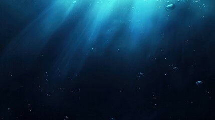 Obraz premium Underwater scene shows sunbeams penetrating deep ocean depths.