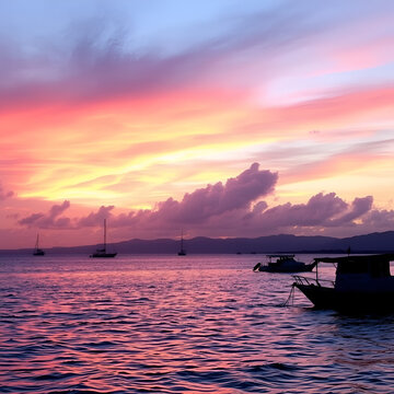 Cloudy Afternoon on C4 Navotas: Pink and Purple Hues Reflecting on the Ocean with Boats Silhouetted Against a Tranquil Horizon.