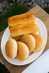 Sausage rolls, hot dogs and burger buns in a plate, cooking bbq