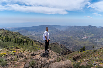 Obraz premium Young man hiking at the top of Gran Canaria Island in a sunny day. Canary islands. Spain