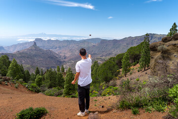 Fototapeta premium Young man hiking at the top of Gran Canaria Island in a sunny day. Canary islands. Spain