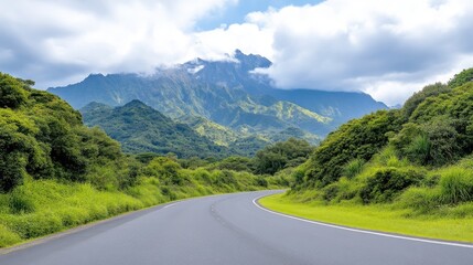 Fototapeta premium Mountain Road Lush Greenery Scenic Vista High-resolution Vivid Colors Wide Angle Panoramic View Winding Journey Mountainous Backdrop Verdant Serene Tones Travel Advertisement
