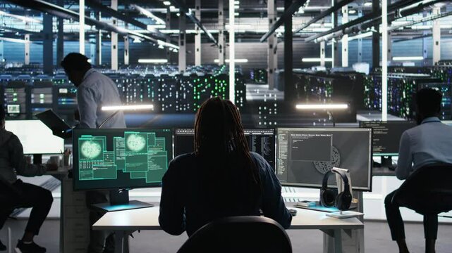 Server hub engineering team rushes to stop cyberattack targeting confidential information. Data center colleagues working together during security breach to contain virus and protect systems, camera A
