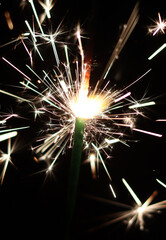 A sparkler creating a beautiful light show against the dark backdrop