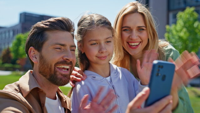 Positive family video call mobile phone on picnic sitting green grass closeup