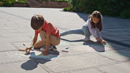 Brother sister drawing crayons sunny street. Little children creating pictures