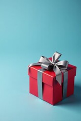 Obraz premium Red striped gift box with grey bow, blue-grey background , holiday, red, dad