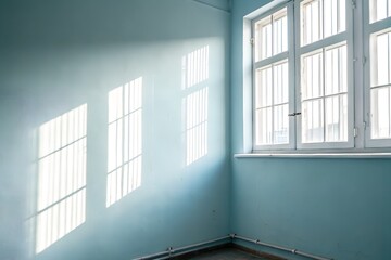 Fototapeta premium Light Streaming Through A White Framed Window Illuminating A Blue Corner Room
