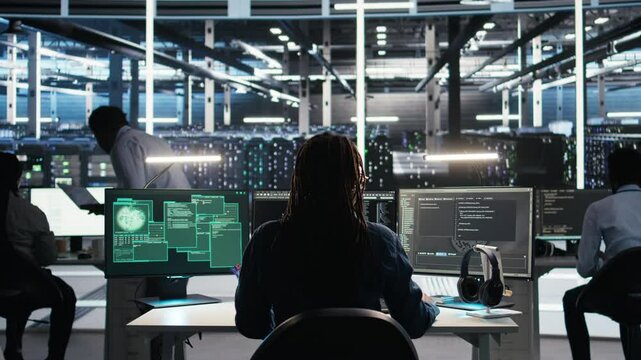 Cybersecurity team in data center responds to security breach, trying to prevent unauthorized access. Workers rushing to secure servers and protect sensitive information during cyberattack, camera A