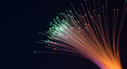 Close up shot of illuminated fiber optics against a dark background with vibrant colors