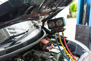 Car refilling air condition at car garage