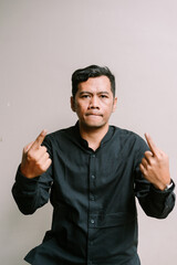 Annoyed man shows middle finger with defiant expression portrait