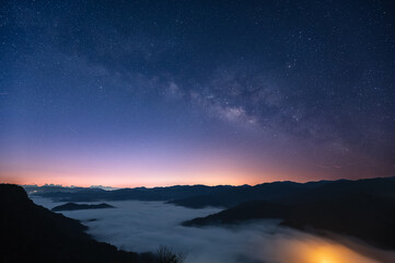 Magnificent view of the Milky Way starry sky and sea of ​​clouds above the mountains in Xindian District, New Taipei City, Taiwan.