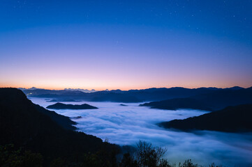 A breathtaking view of stars and clouds over mountain ridges in Xindian, Taiwan. A perfect stock video for nature and travel themes.