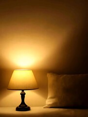 Warm Yellow Table Lamp Illuminates Beige Pillow on Bedside Table