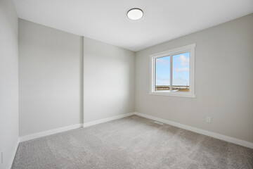 Very clean and empty room with a large window
