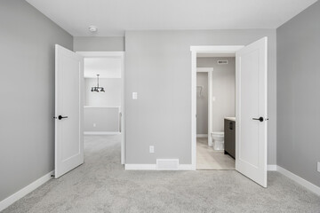 Large, empty room with a toilet and a sink