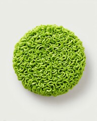 Instant noodle block A vibrant green circular object with a textured surface, resembling noodles. Perfect for creative culinary presentations.