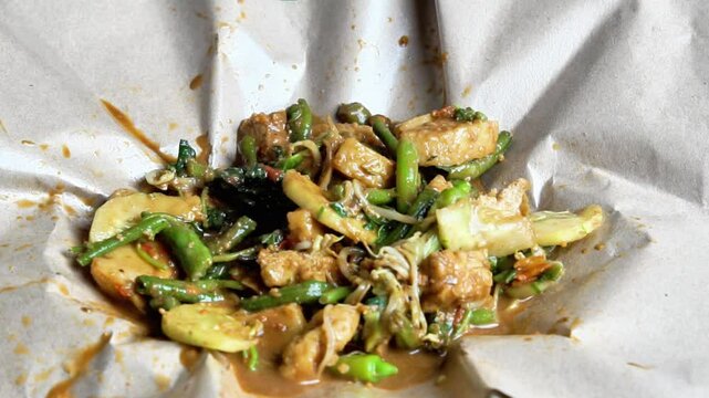 Rujak ulek. Indonesian salad, rice cake with various vegetables, peanut sauce and shrimp paste.