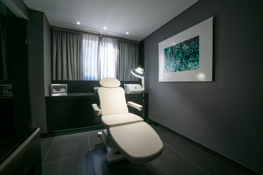 Modern Medical Examination Room With Comfortable Chair and Creative Artwork