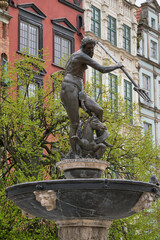A grand fountain adorned with a statue of a man holding a trident proudly