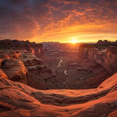 &nbsp;Vast canyon opening beneath sunrise sky, golden light illuminating layered rock, a monument to time shaped by wind and water.