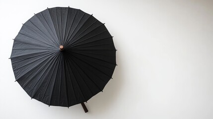 Against a crisp white backdrop, a stylish black Japanese parasol with a natural bamboo handle is presented, capturing the essence of Asian aesthetics and the joy of sun-kissed life