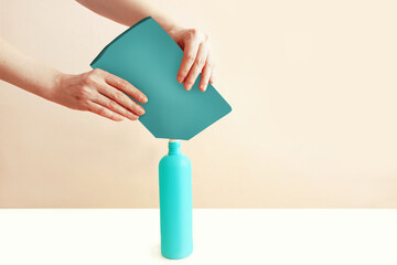 Pour detergent from a doy pack into a reusable plastic bottle.