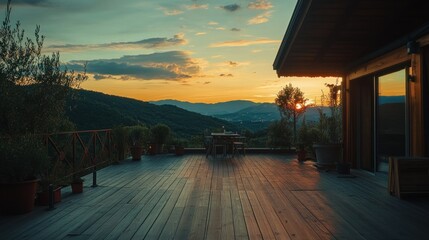 A scenic outdoor patio view of the mountains at sunset