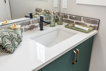Bathroom sink with a green cabinet and a white countertop