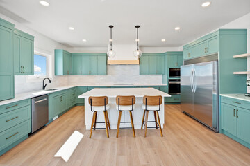 Kitchen with a green color theme and white countertops