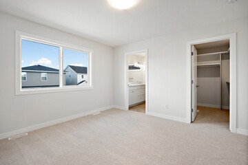 Large, empty room with a window and a closet