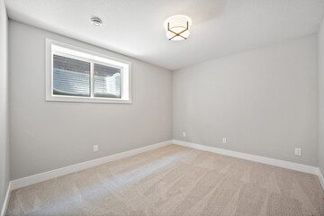 Very clean and empty room with a window and a light fixture