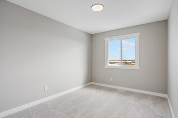 Very clean and empty room with a window