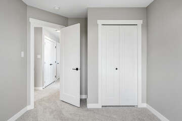 White room with a door that is open