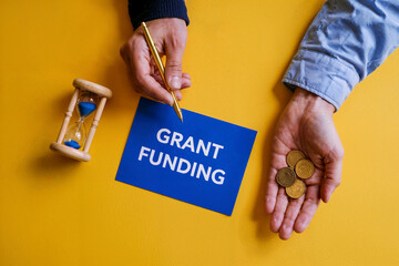 Grant Funding Application Process Time Management Financial Aid Business Concept Blue Note Coins Hourglass Yellow Background Deadline Important Planning Strategy Financial Assistance Successful       