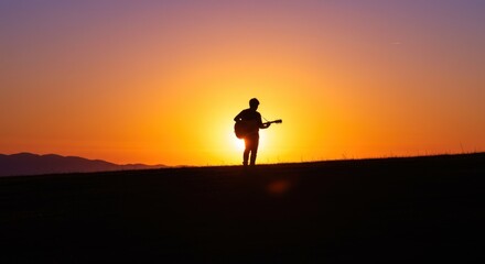 Silhouette of a Guitarist at Sunset - Photo