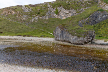 Smoo Cave in the Scottish Highlands captivates with its wide coastal opening and water-carved...