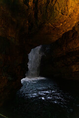 Smoo Cave in the Scottish Highlands captivates with its wide coastal opening and water-carved...