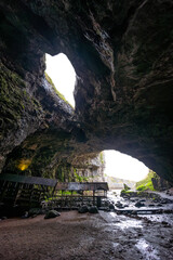 Smoo Cave in the Scottish Highlands captivates with its wide coastal opening and water-carved...