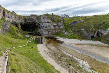 Smoo Cave in the Scottish Highlands captivates with its wide coastal opening and water-carved...