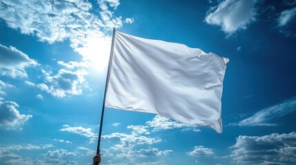 A white flag waving on a black flagpole held by a person under a blue sky with scattered clouds.