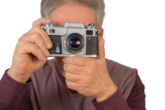 Man holding a vintage camera and preparing to take a photograph, isolated on transparent background
