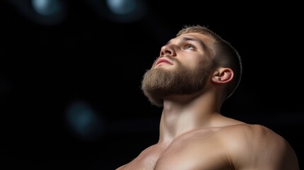 Muscular man looking upwards