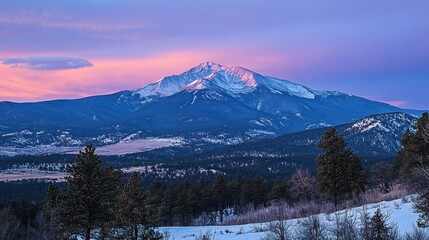 A majestic mountain range is illuminated by a colorful sunset