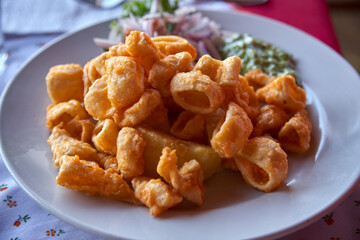 Peruvian Chicharrón de Calamar is a delightful dish featuring deep-fried calamari, often served as an appetizer or snack. It's known for its crispy texture and flavorful seasoning.
