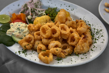Peruvian Chicharrón de Calamar is a delightful dish featuring deep-fried calamari, often served as an appetizer or snack. It's known for its crispy texture and flavorful seasoning.
