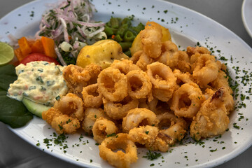 Peruvian Chicharrón de Calamar is a delightful dish featuring deep-fried calamari, often served as an appetizer or snack. It's known for its crispy texture and flavorful seasoning.
