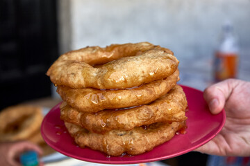 Peruvian picarones are a traditional dessert commonly found in Peru. They are a type of doughnut made from a sweet potato and pumpkin batter, which is deep-fried until golden brown