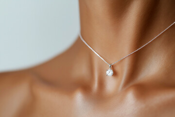 A close-up image of a woman wearing a simple yet elegant necklace, highlighting sophistication and minimalist jewelry design often seen in fashion and luxury accessories.